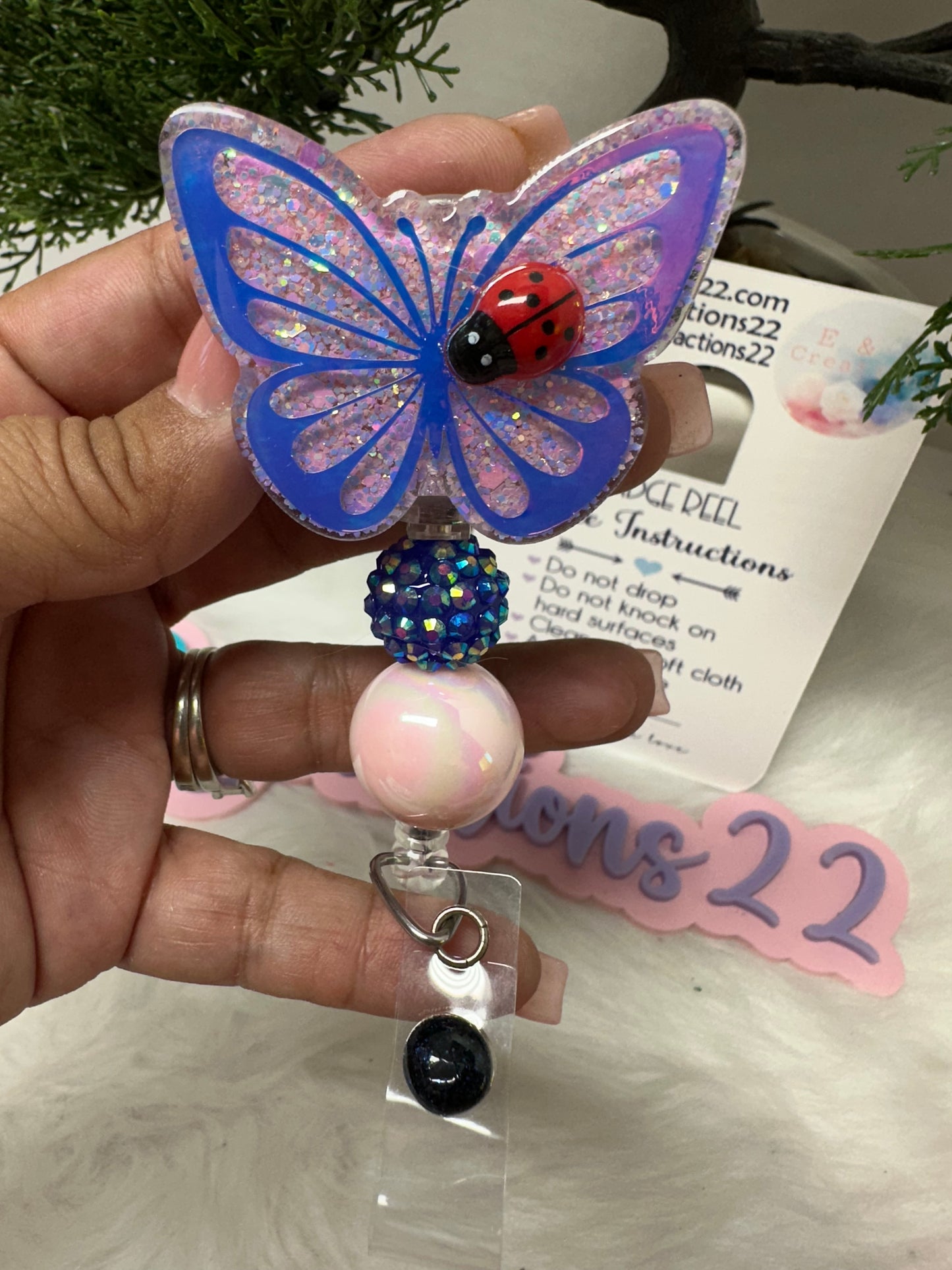 Butterfly with Ladybug Badge Reel