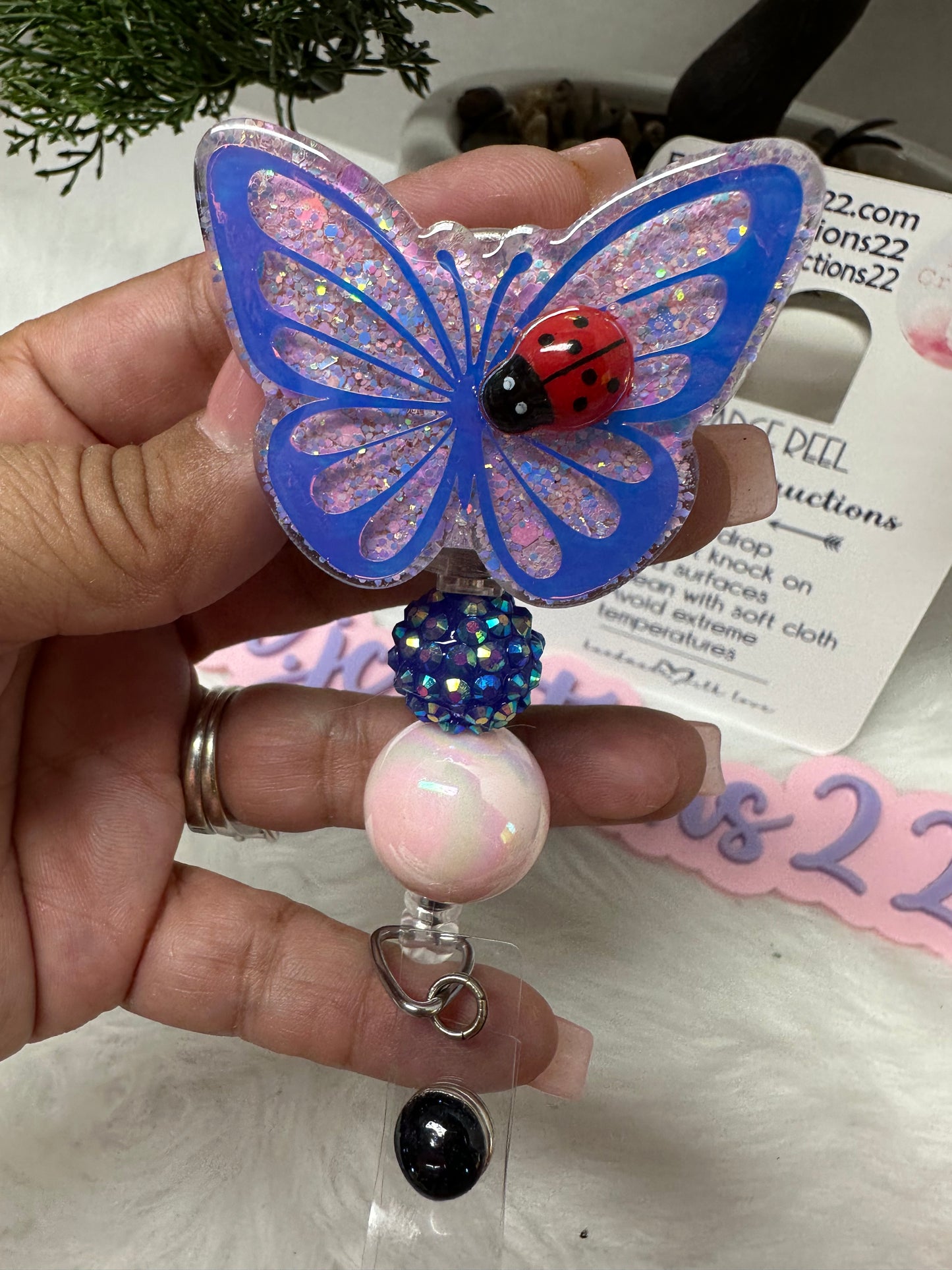 Butterfly with Ladybug Badge Reel