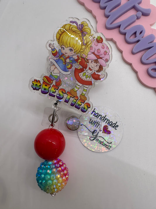 This cute and colorful Besties Strawberry and rainbow girl  badge Reel is an excellent  accessory to your scrubs, shirt pocket, belt loop, lanyard and more.  They make super fun and useful gifts for any person in any profession.  A great gift choice for nurses, medical staff, office staff, and anyone who is required to wear a badge! 80s-character badge reels