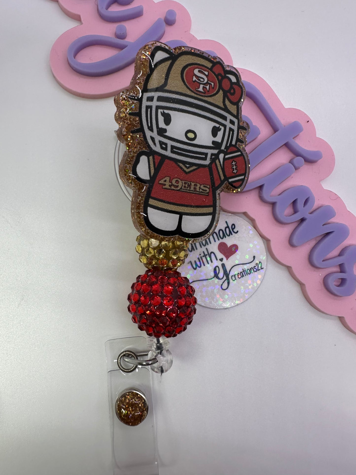 Kitty Red & Gold Badge Reel