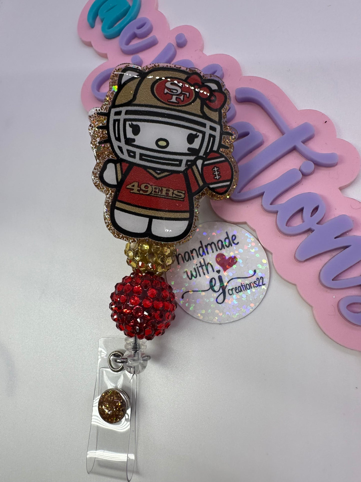 Kitty Red & Gold Badge Reel